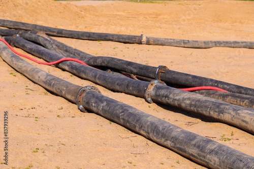 Pipes on the beach for pond cleaning photo