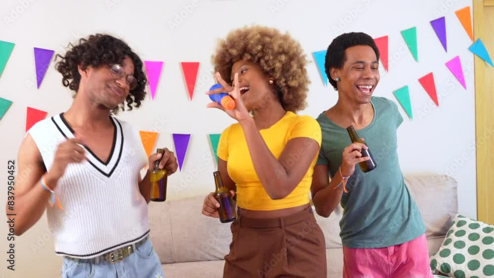 Happy multi-ethnic friends singing and dancing karaoke together during party at home Happy multi-ethnic friends singing and dancing karaoke together during party at home