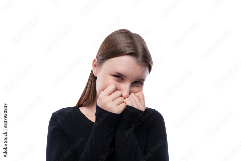 European shy fair-haired teenage girl dressed in a black turtleneck asks for a request European shy fair-haired teenage girl dressed in a black turtleneck asks for a request