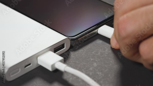 Charging smartphone with power bank.