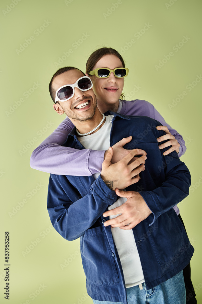 A couple of people, two men, hugging each other in a warm embrace, showing affection. A couple of people, two men, hugging each other in a warm embrace, showing affection.