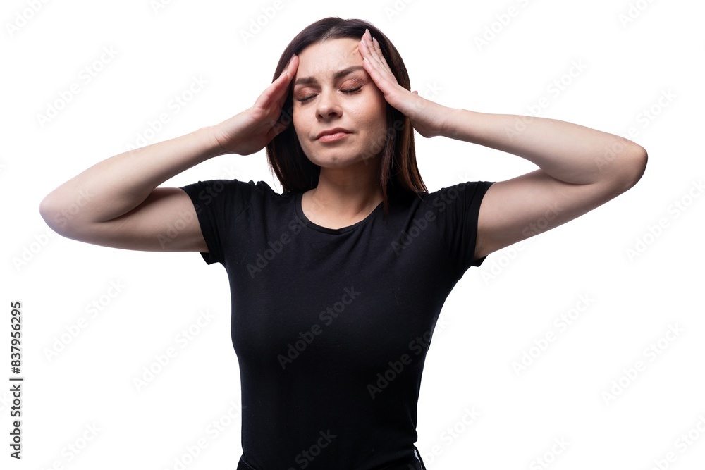 Young calm woman relaxes with her eyes closed