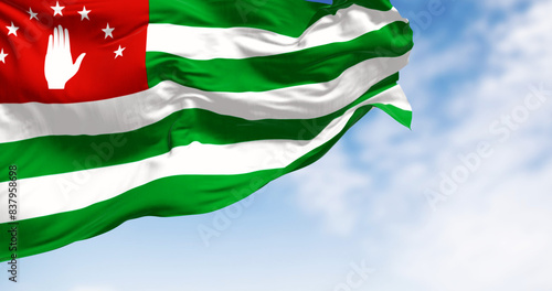 National flag of Abkhazia waving in the wind on a clear day photo