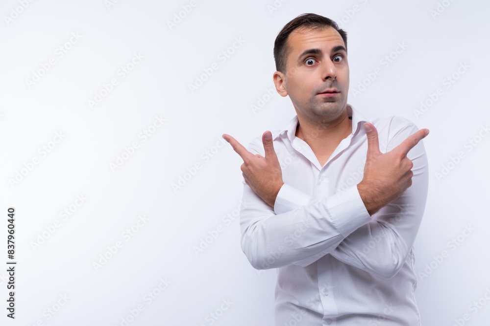 A 40-year-old brunette man dressed in a white shirt crossed his arms in front of him A 40-year-old brunette man dressed in a white shirt crossed his arms in front of him