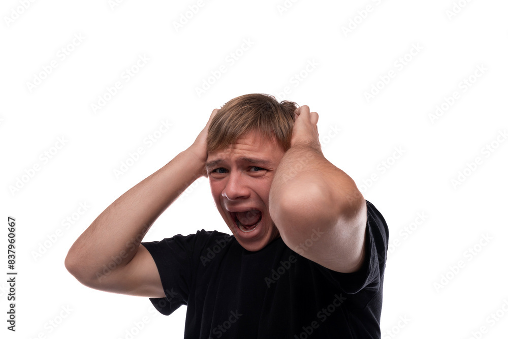 Fototapeta premium Talking Caucasian blond 16 year old guy dressed in a black T-shirt