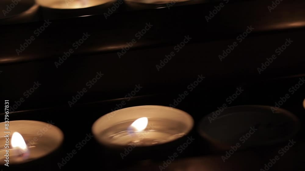 Lighted candles in the dark of the church. A light that gives hope and remembers our departed Lighted candles in the dark of the church. A light that gives hope and remembers our departed