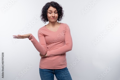 Bild auf Leinwand Cute brunette curly woman has mixed feelings