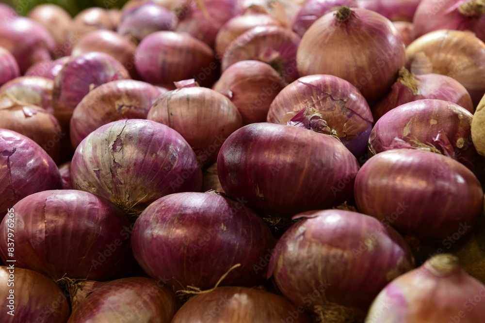 Onions at a vegetable stall at a market Onions at a vegetable stall at a market