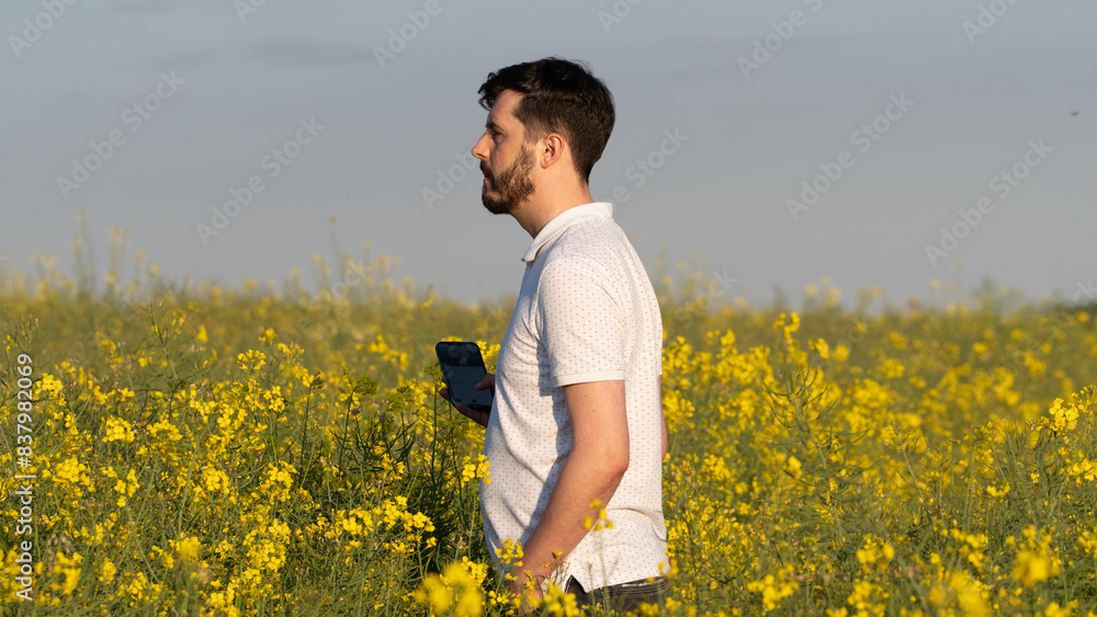 Golden Hour Bliss: Joyful Hiker Standing in a Blooming Yellow Meadow Golden Hour Bliss: Joyful Hiker Standing in a Blooming Yellow Meadow