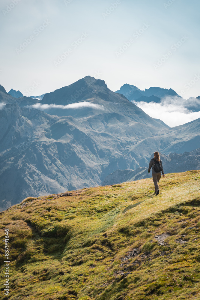 Young Woman With A Backpack on The Top Of a Beautiful wild Landscape. High quality photo