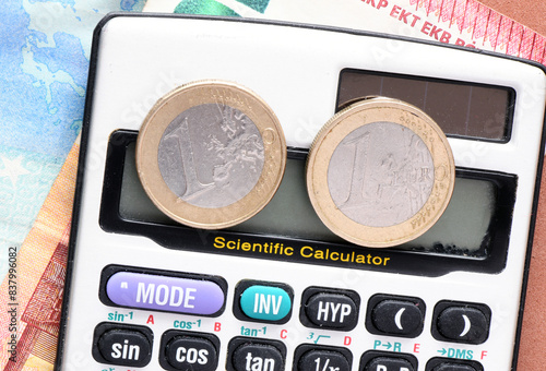 1 euro coin on the screen of the calculator. Concept for business.
