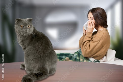 Cuadro en lienzo young person sneezing from cat allergy at home.