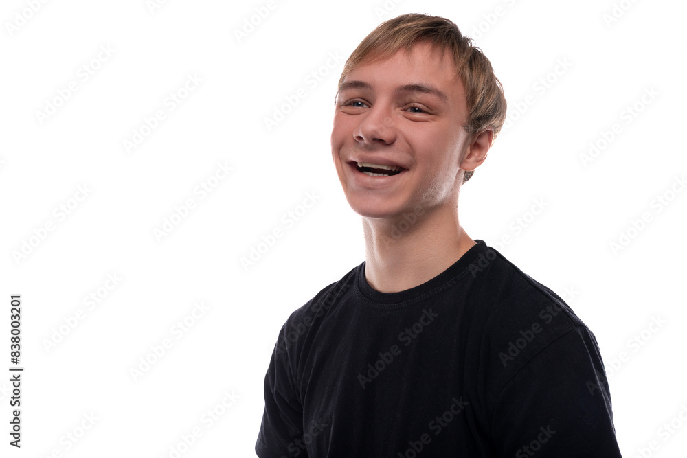 Handsome Caucasian blond teenager guy in a black T-shirt is friendly Handsome Caucasian blond teenager guy in a black T-shirt is friendly