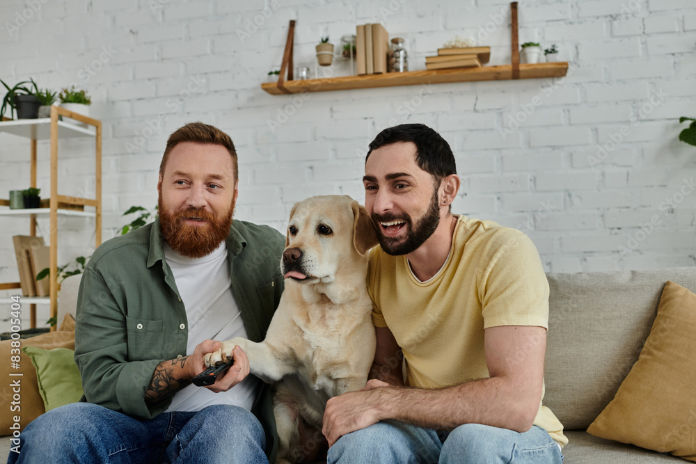 Bearded gay couple enjoying quality time with their furry friend, a labrador, lounging on a cozy couch at home. Bearded gay couple enjoying quality time with their furry friend, a labrador, lounging on a cozy couch at home.