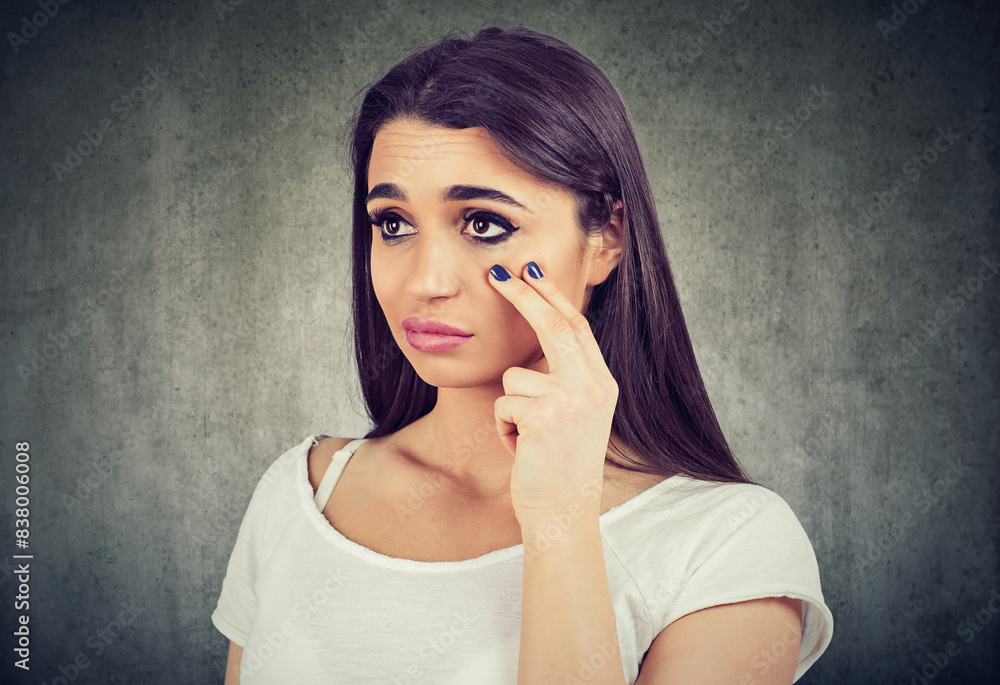 woman pulling down eyelid checking her eye looking in morrow feels unwell has black circles woman pulling down eyelid checking her eye looking in morrow feels unwell has black circles