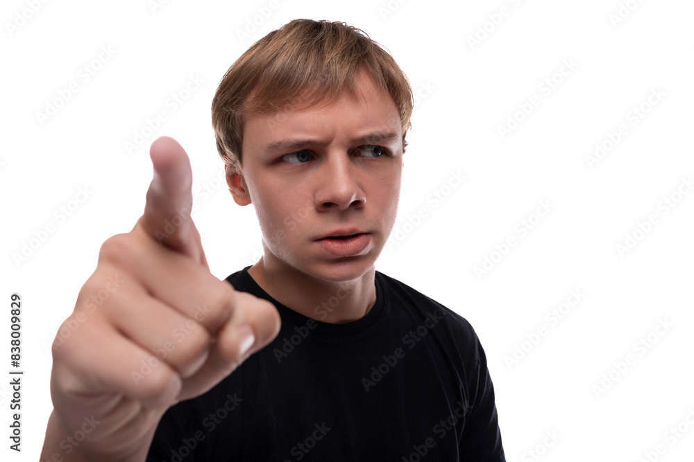 Headshot portrait of a suspicious blond Caucasian guy with blond hair looking from under his brows Headshot portrait of a suspicious blond Caucasian guy with blond hair looking from under his brows