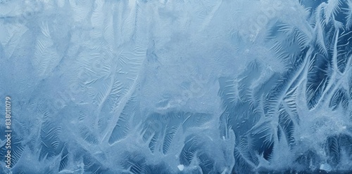 frost texture on a frosted window pane, with a red and white striped pattern visible in the foreground photo