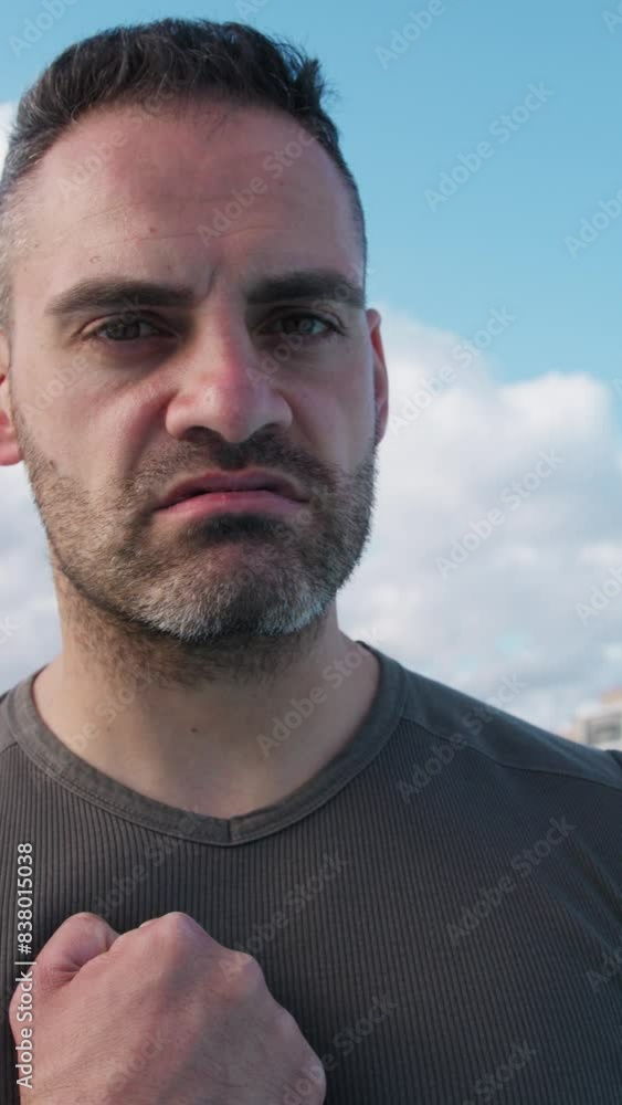 Athlete Looks Into The Camera And Intimidates By Beating His Fist On His Chest Athlete Looks Into The Camera And Intimidates By Beating His Fist On His Chest