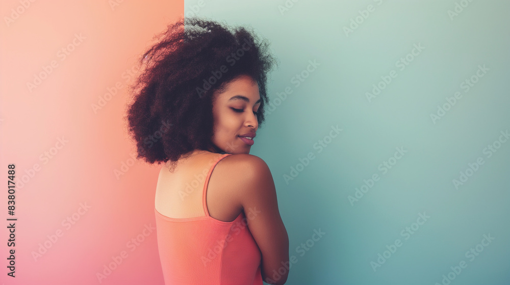 A natural, unretouched photo of a girl standing back, hugging herself softly, promoting body positivity over a pastel color background. A natural, unretouched photo of a girl standing back, hugging herself softly, promoting body positivity over a pastel color background.