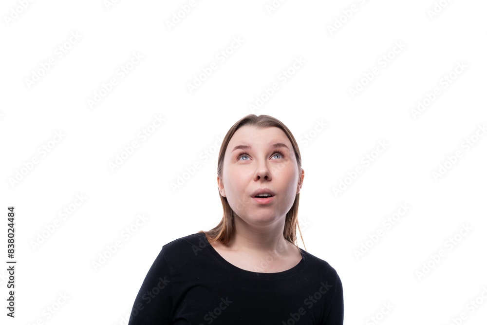 Close-up portrait of a surprised fair-haired 12 year old girl on a white background Close-up portrait of a surprised fair-haired 12 year old girl on a white background