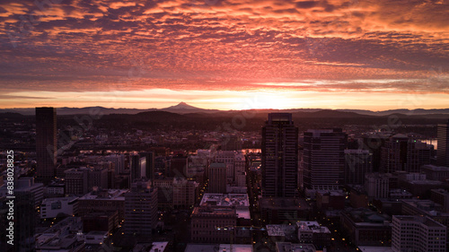 The sun rises over Portland, Oregon, with the Columbia River and Cascadia Mountains photo