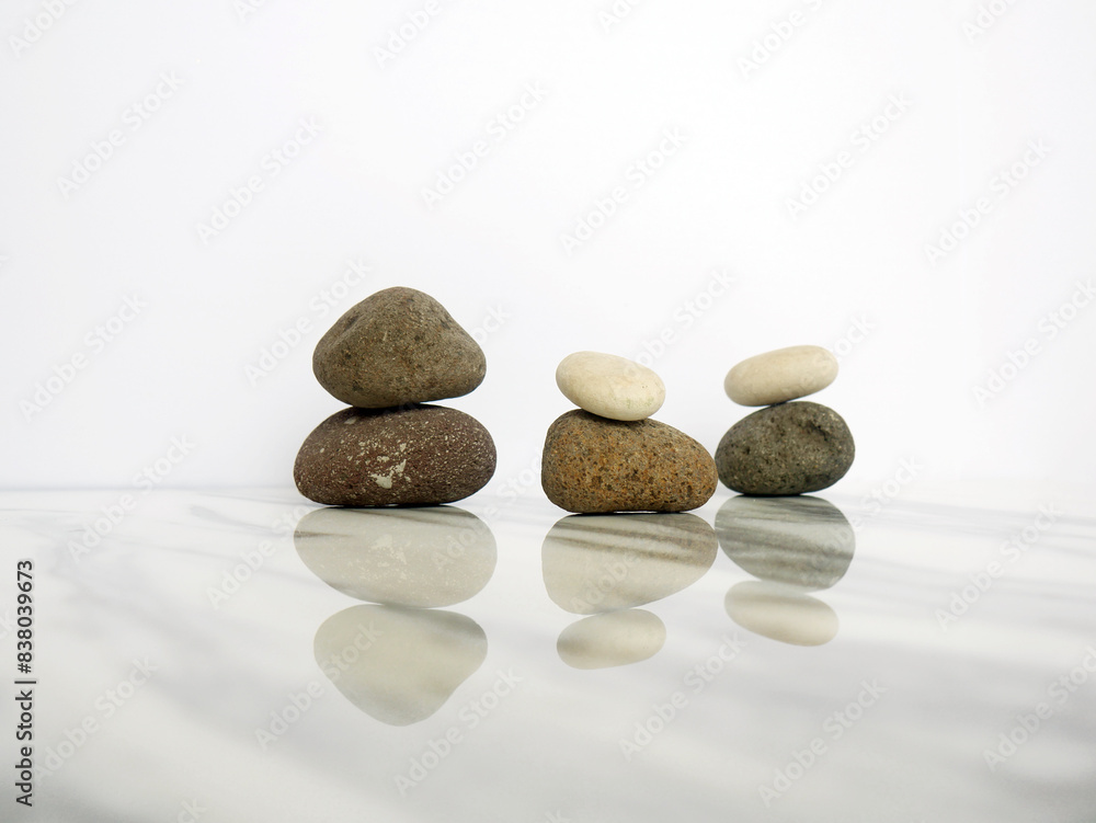Zen basalt stone on white marble background Zen basalt stone on white marble background