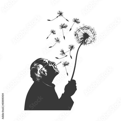 Silhouette of elder blowing dandelion seeds, ephemeral dreams.