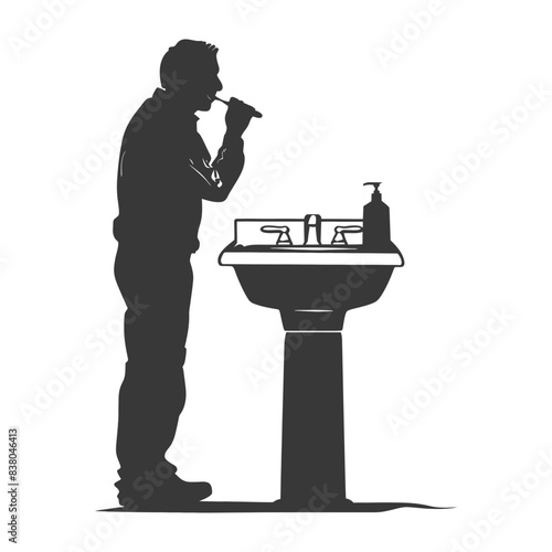 Silhouette of man brushing teeth at pedestal sink.