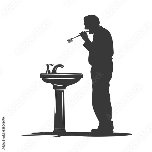 Silhouette of man brushing teeth at pedestal sink.
