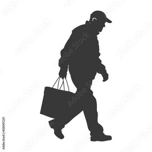 Silhouette of older man walking with shopping bag, cap and stooped posture.