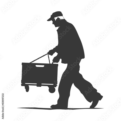 Silhouetted man hauling a wheeled crate, delivery or moving concept.