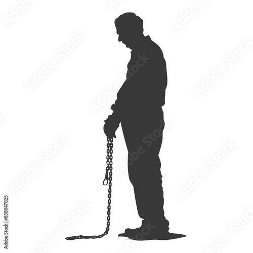 Silhouette of a man with a lowered head holding a heavy chain.