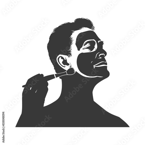 Silhouette of man applying face mask with brush.