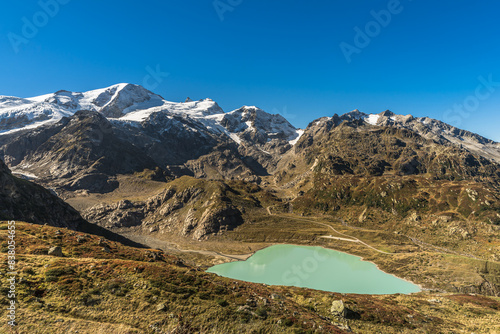 Landscape with snowcapped mountains and view of Steinsee, a glacial lake at Susten Pass, Innertkirchen, Canton of Bern, Switzerland photo
