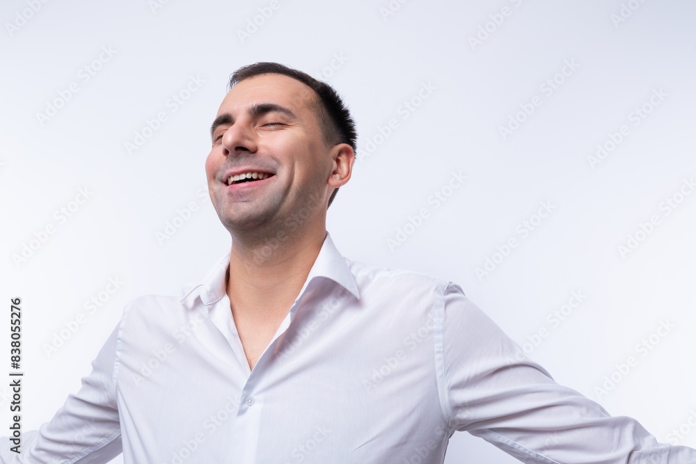 Confident Caucasian man wearing a white shirt on a white background Confident Caucasian man wearing a white shirt on a white background