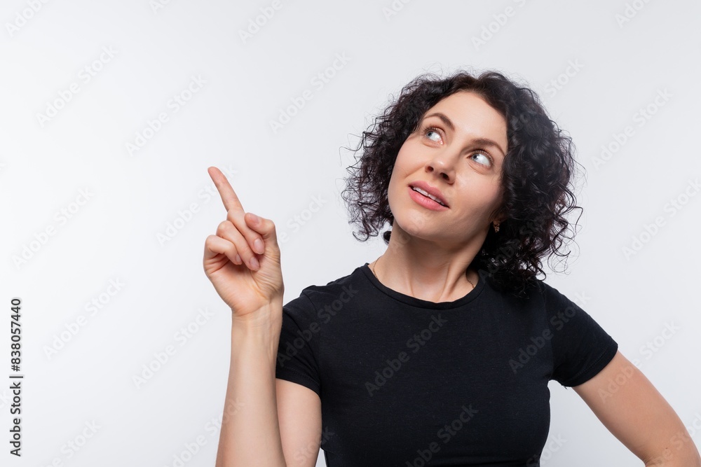 Beautiful brunette woman with curly bob hairstyle keeps a secret Beautiful brunette woman with curly bob hairstyle keeps a secret
