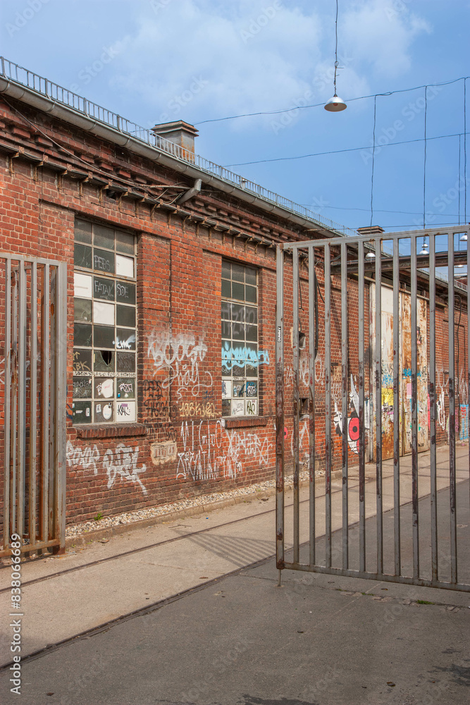 alley with old buildings and a fence. alley with old buildings and a fence.