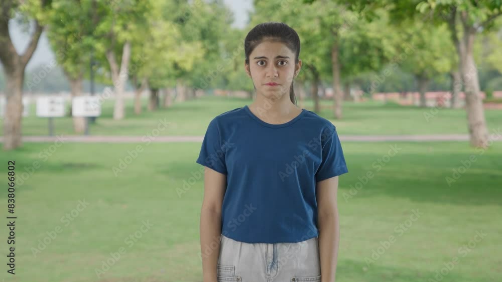 Scared Indian teenage girl scared of someone in park Scared Indian teenage girl scared of someone in park