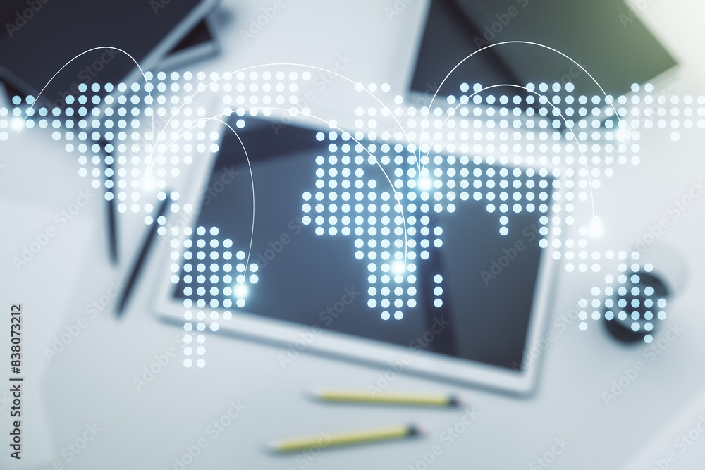 Abstract creative world map with connections and modern digital tablet on background, top view, international trading concept. Multiexposure