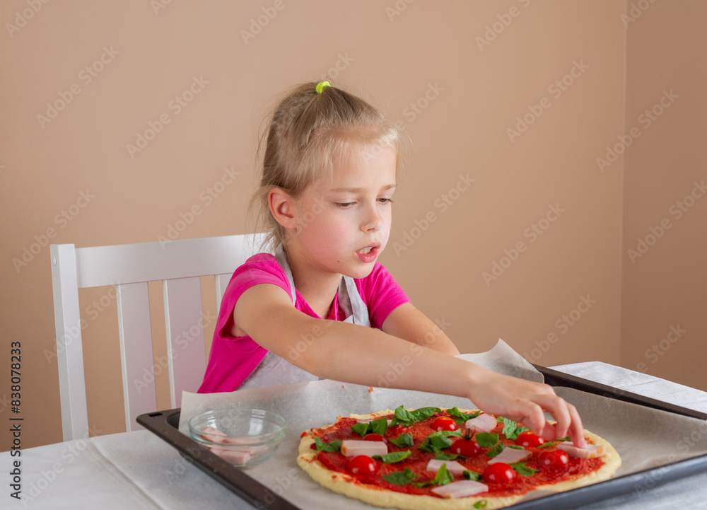 Girl is preparing pizza, she puts ham on pizza dough. Yeast-free pizza, homemade, handmade, DIY pizza.