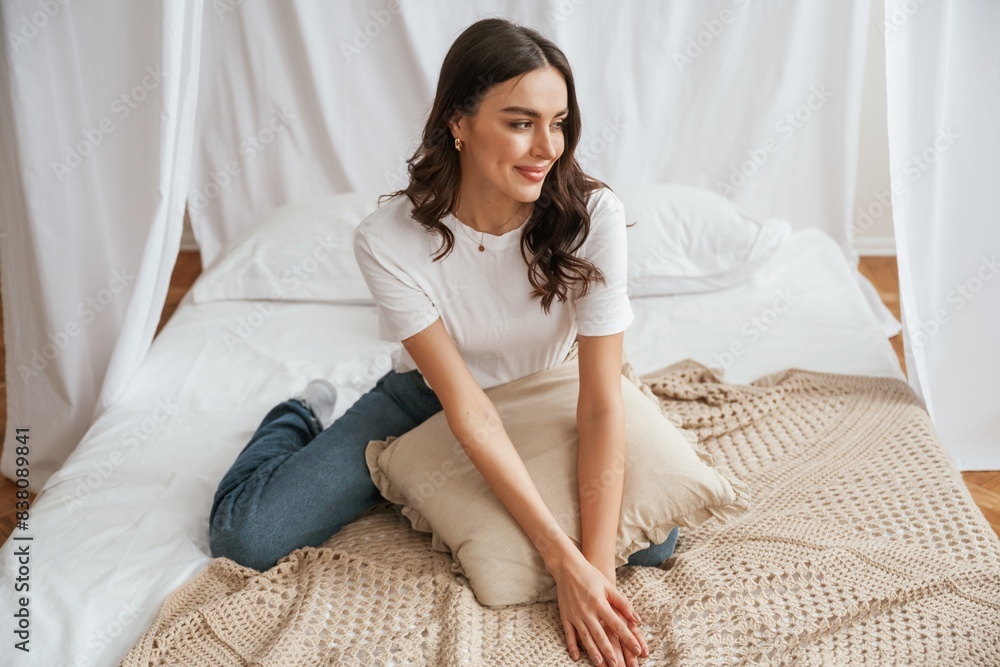 Young beautiful woman is at home on the bed Young beautiful woman is at home on the bed