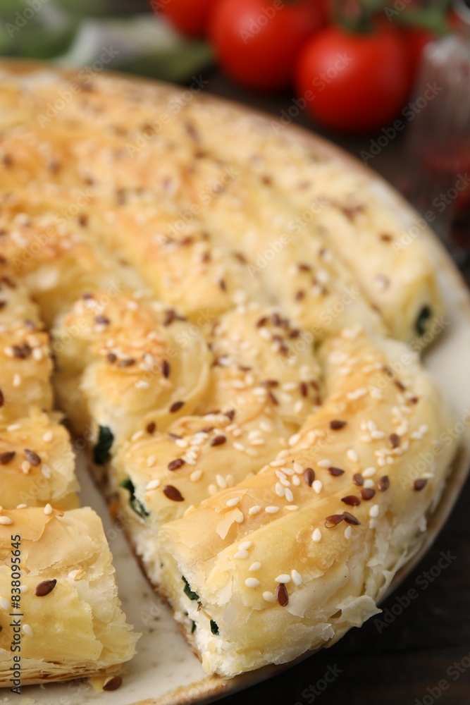 Delicious puff pastry with spinach on table, closeup Delicious puff pastry with spinach on table, closeup