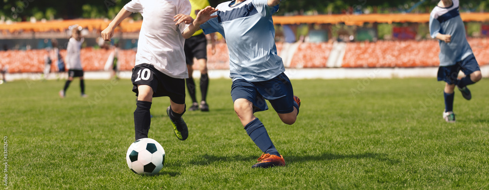 Two Kids Playing Football Ball on Grass Field. Happy School Boys Kicking Ball During Tournament Game. Children in Blue and White Soccer Team Two Kids Playing Football Ball on Grass Field. Happy School Boys Kicking Ball During Tournament Game. Children in Blue and White Soccer Team