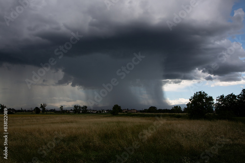 Tableau sur toile Tornado over cultivated fields, flat landscape