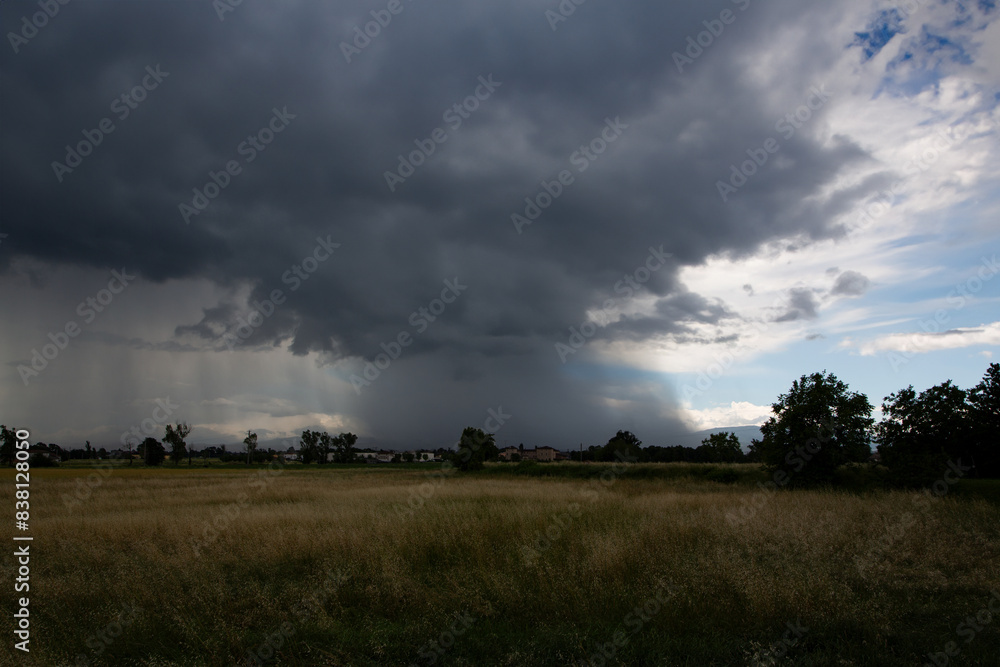 Tornado over cultivated fields, flat landscape Tornado over cultivated fields, flat landscape