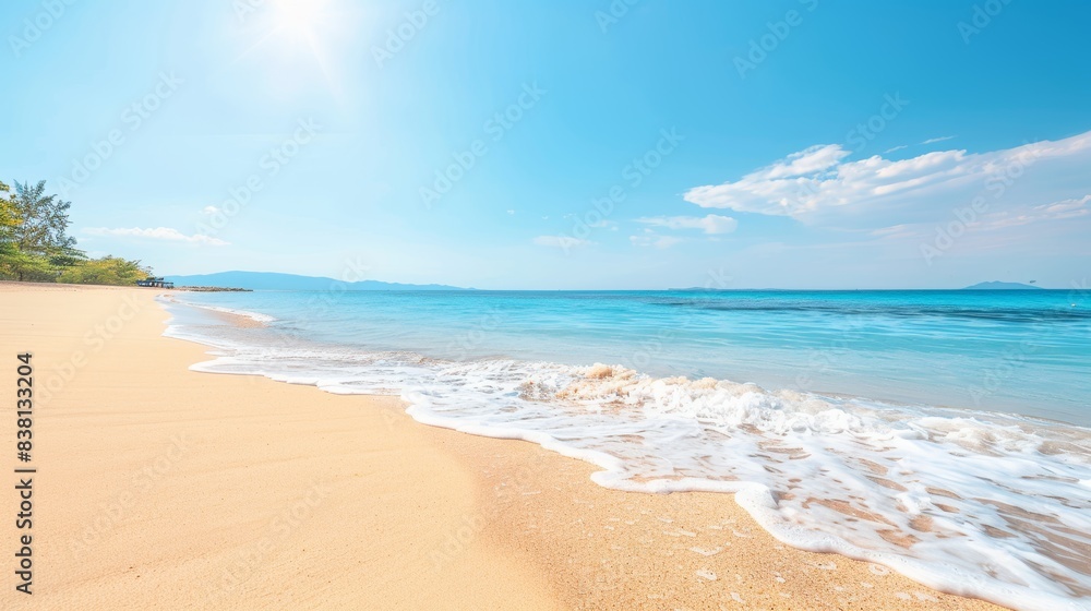 Tranquil Tropical Beach Scene with Crystal Clear Water, Golden Sand, and Sunny Blue Skies