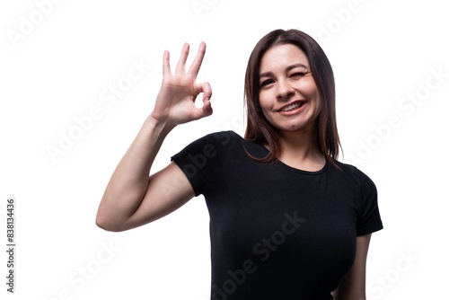 Wallpaper Mural Positive pretty young brunette woman wearing a black t-shirt on a white background with copy space Torontodigital.ca
