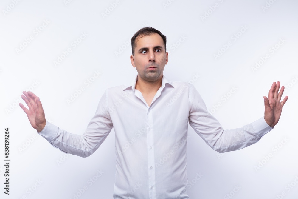 Pensive handsome Caucasian man in a white shirt on a white background Pensive handsome Caucasian man in a white shirt on a white background