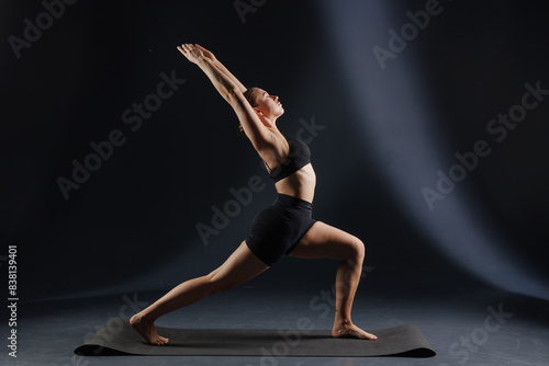 girl doing yoga and stretching, yoga and stretching poses on a dark background, yoga practice