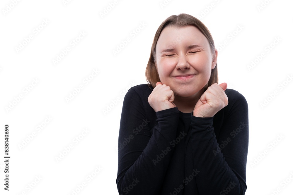 Happy cheerful school age girl dressed in black clothes on a white background Happy cheerful school age girl dressed in black clothes on a white background